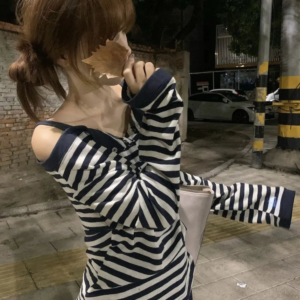 Dark blue women's long-sleeved oversized T-shirt with embroidery and striped detail on a hanger.