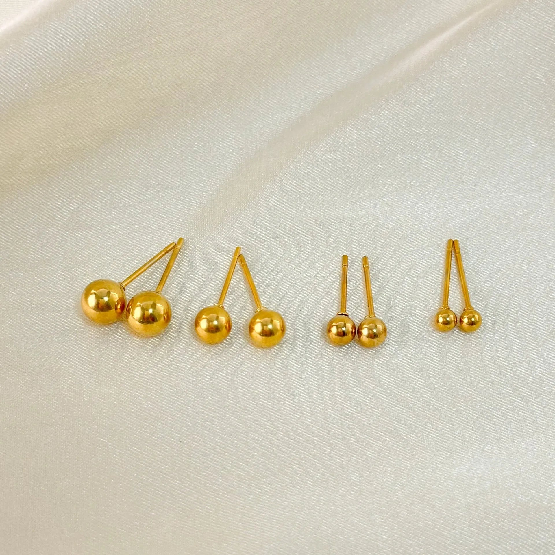 Stainless steel ball stud earrings with geometric round design and gold electroplated finish