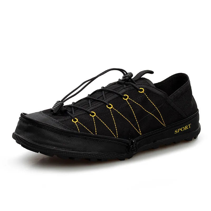 Orange foldable outdoor shoes with mesh upper and side zipper, shown next to a backpack.