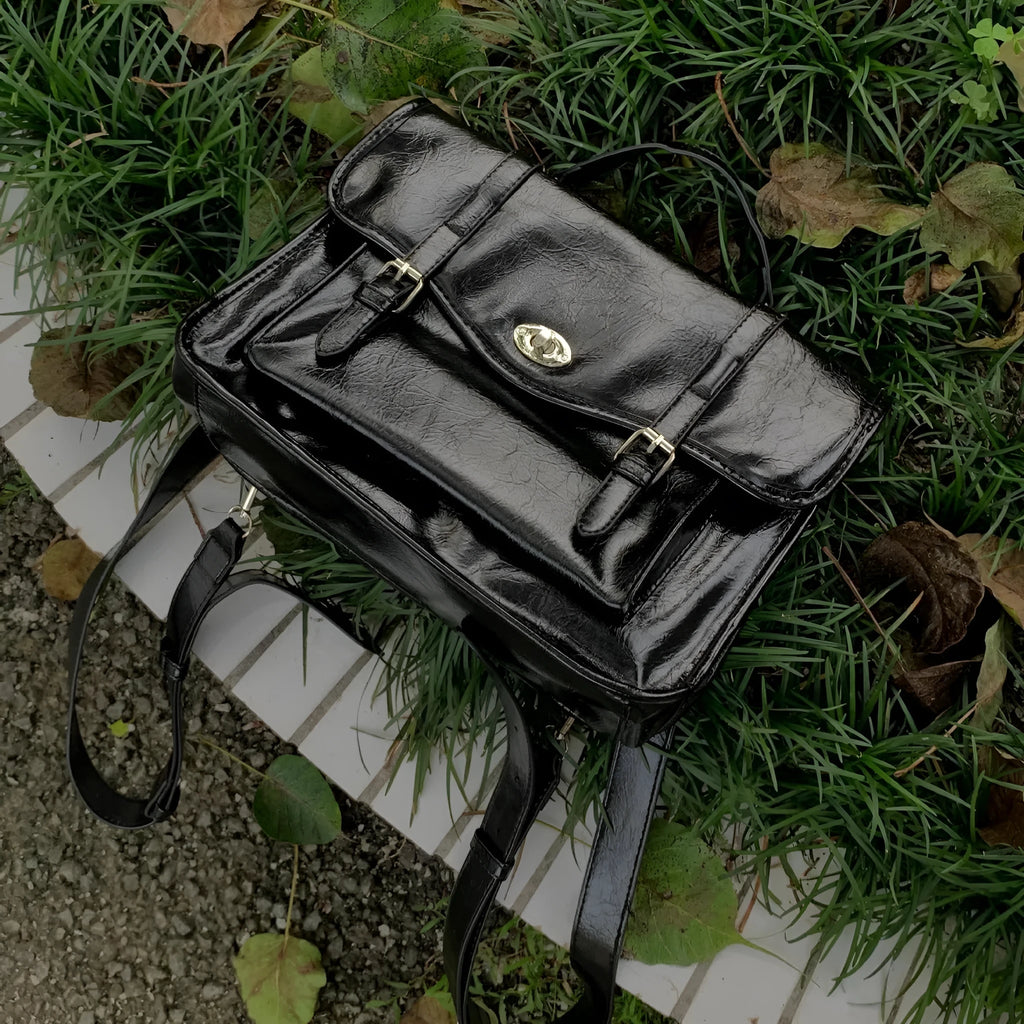 Black college style messenger bag with oil wax leather texture, dimensions 35cm length
