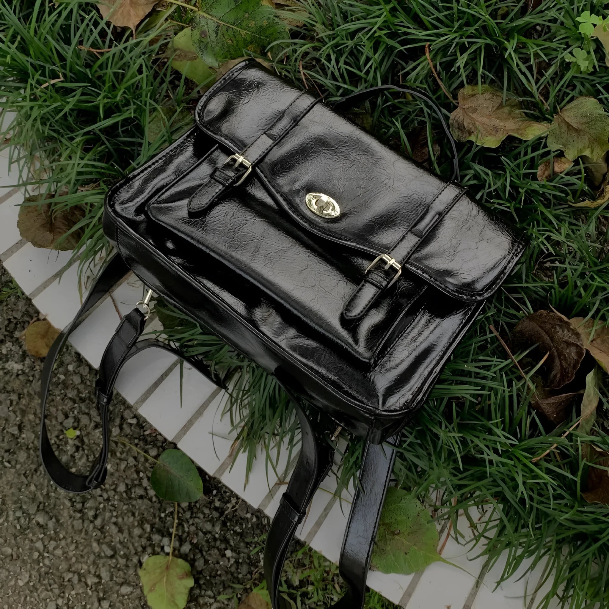 Black college style messenger bag with oil wax leather texture, dimensions 35cm length