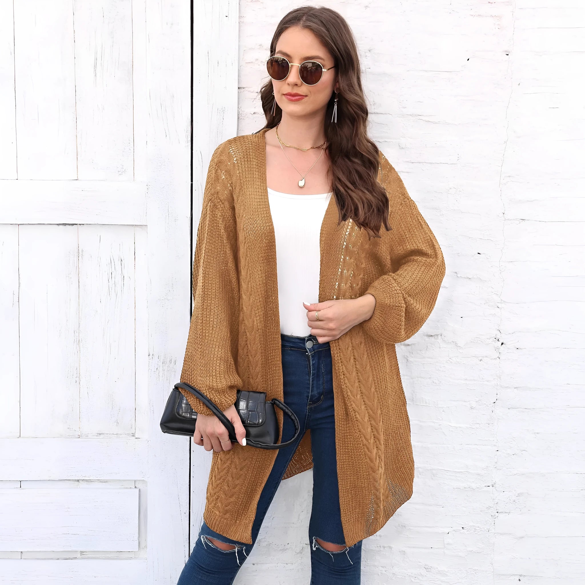 Women's loose fit acrylic sweater coat in a solid colour, shown in a casual setting.