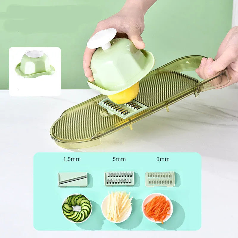 Transparent green kitchen chopper with stainless steel blades and optional drain basket on countertop