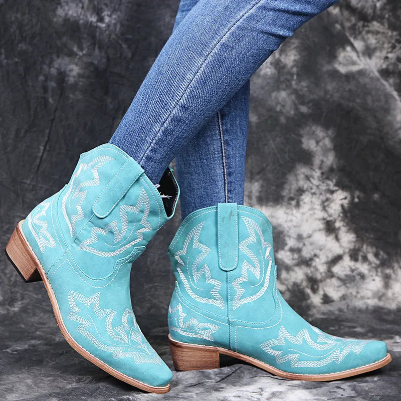 Women's blue cowboy boot with embroidery detail on the side, low wedge heel, and pointed toe.