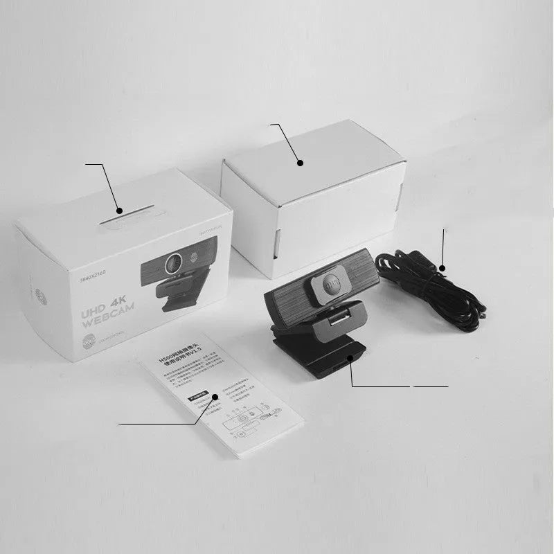 Black USB webcam on a desk with a detached magnetic privacy cover and a 1.7-metre cable