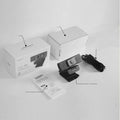 Black USB webcam on a desk with a detached magnetic privacy cover and a 1.7-metre cable