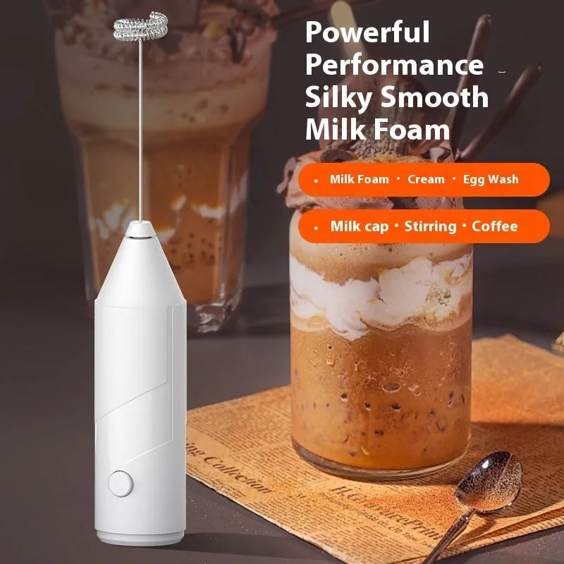 Mini handheld electric milk frother in black, white, and khaki colours with a stainless steel whisk.