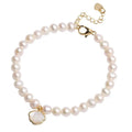Women's fan-shaped freshwater pearl bracelet on wrist showing elastic string and extension chain options