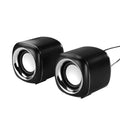A pair of compact black wired desktop computer speakers with a 3.5mm audio cable.