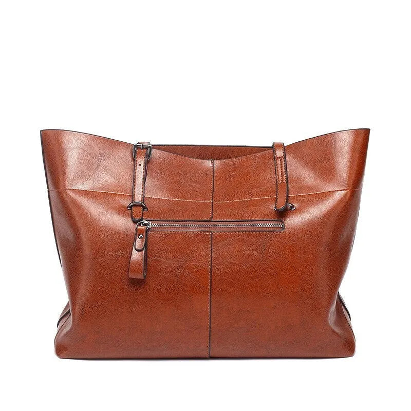 Brown wax cowhide cross-body leather handbag with two compartments showing internal mobile phone pouch.