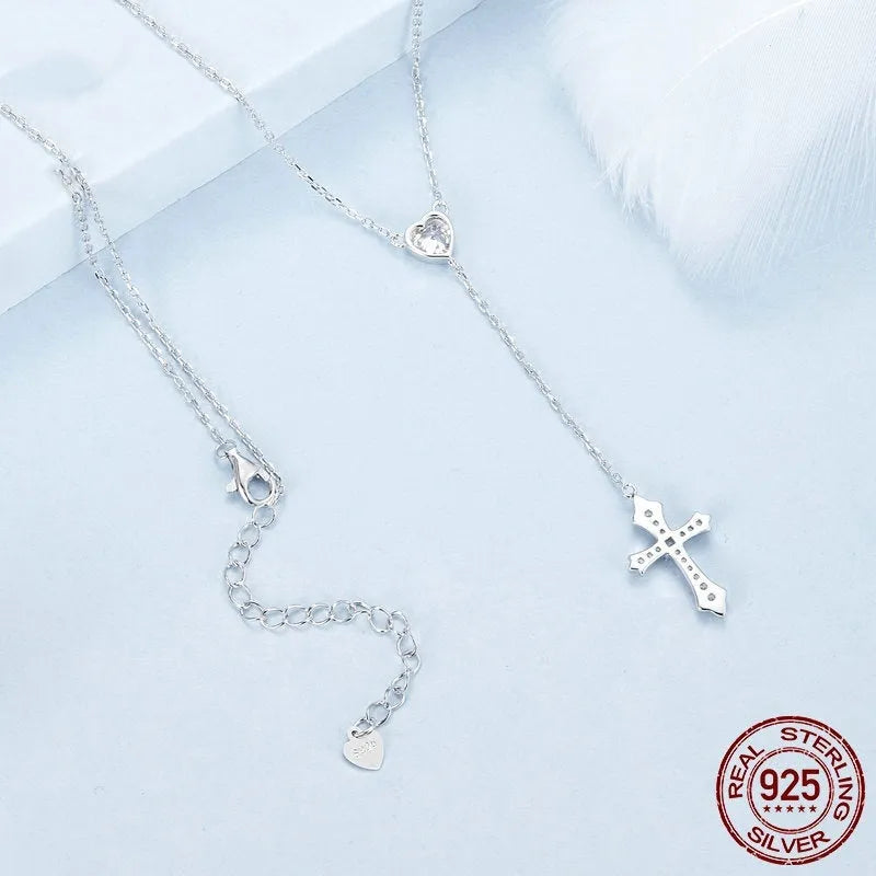 Close-up of a sterling silver V-neck cross pendant on an O-ring chain, colour BSN384.