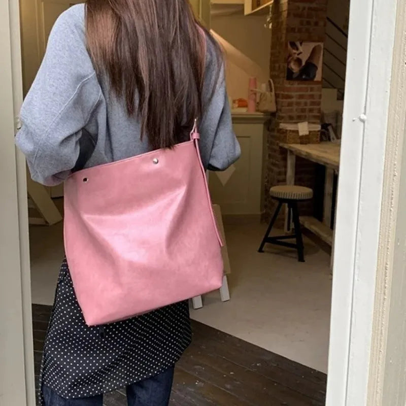 Pink and brown corduroy one-shoulder commuter bag with PU lining.