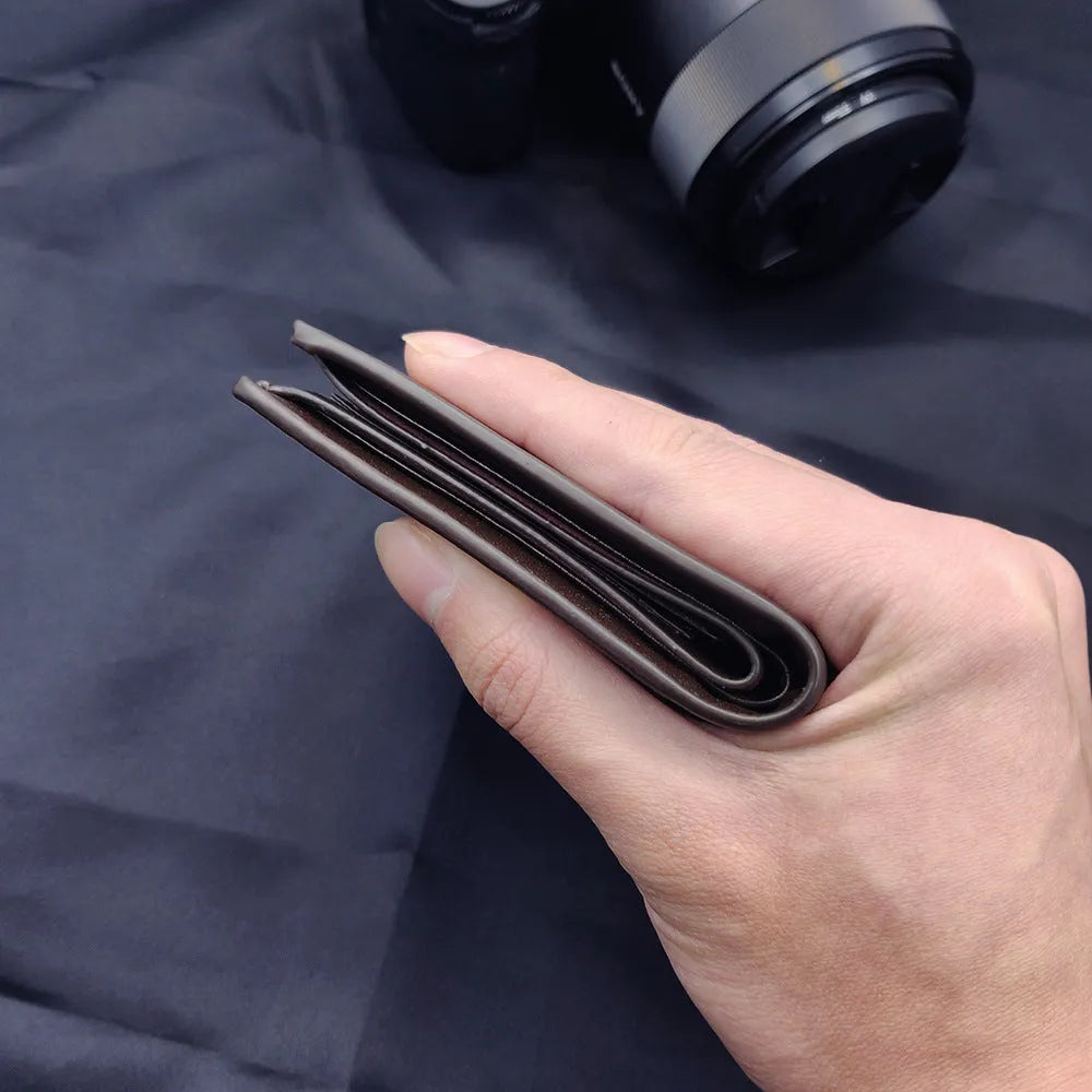 Men's leather wallet with a zip closure, presented as a gift.