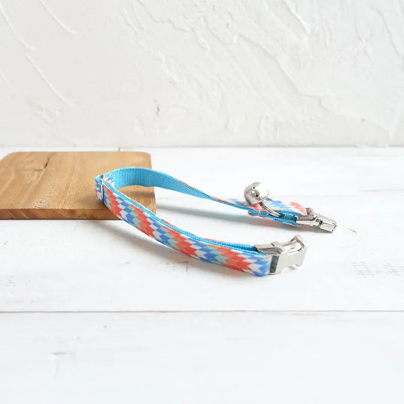 Blue polyester cat collar with printed pattern and lock closure, shown in sizes S and L