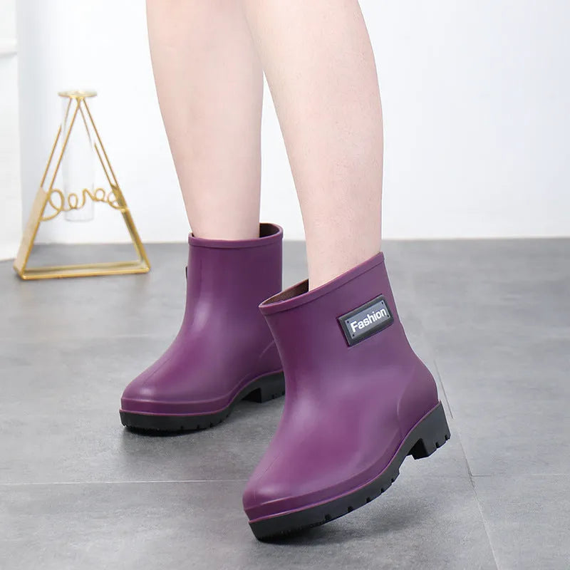 Women's mid-calf rain boot in black PVC with a low heel, shown alongside apricot and brown colour options.