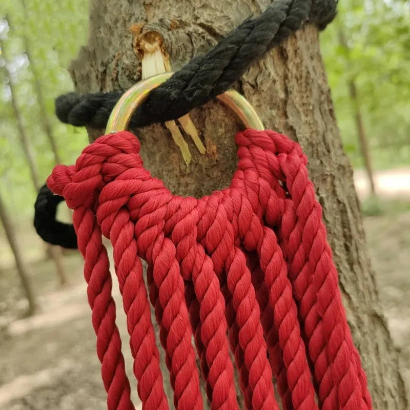 Outdoor nylon rope mesh hammock hanging between trees
