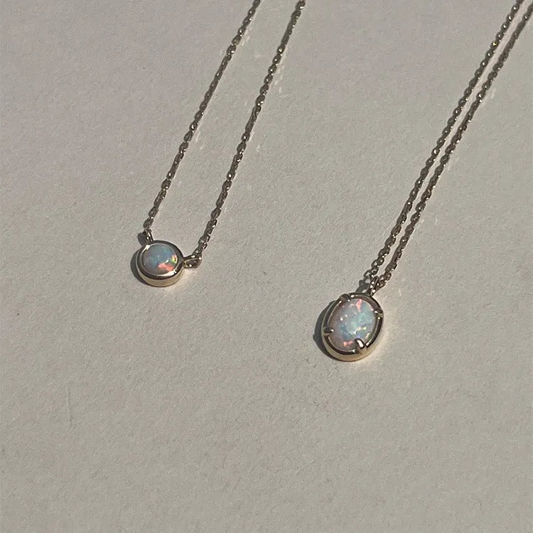 Oval S925 silver pendant necklace with a round jelly opal, shown in both gold tone and white gold tone finishes.