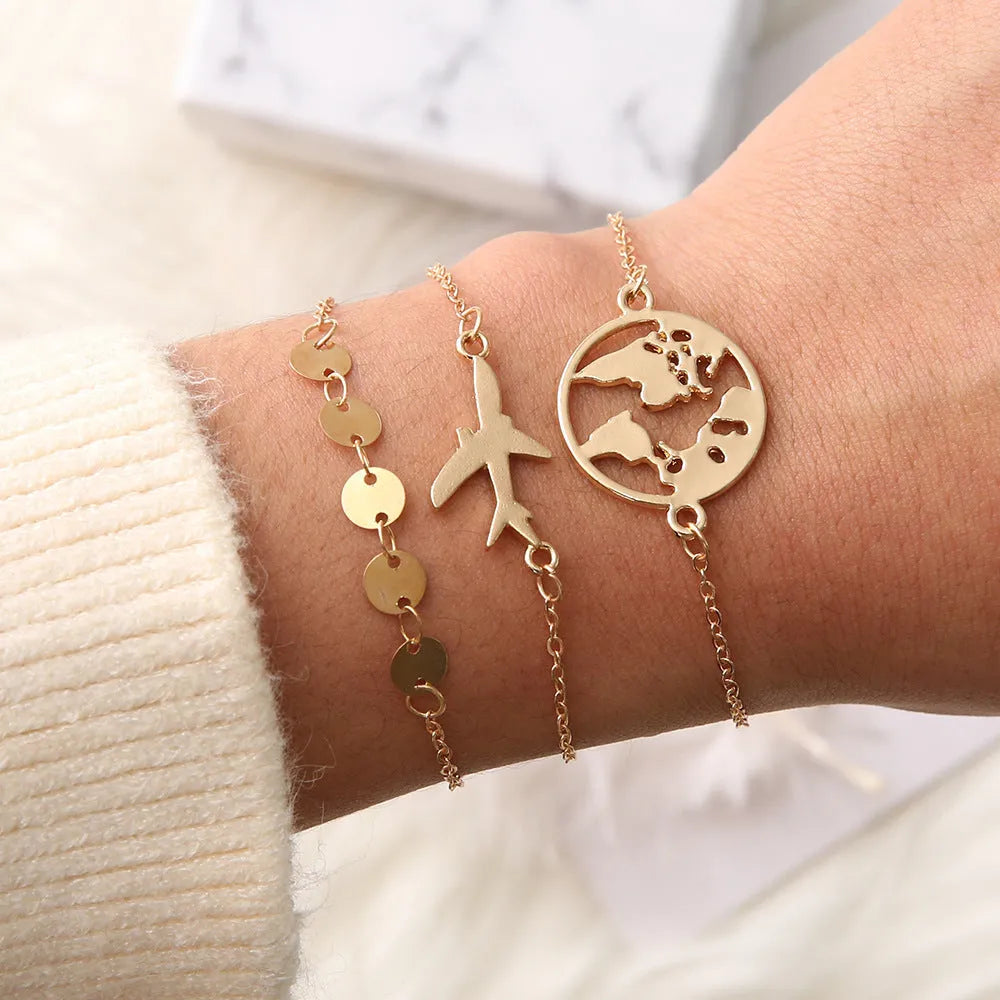 Three bohemian bracelets with heart-shaped aircraft map charms in alloy with electroplated finish