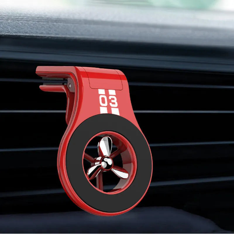 Black magnetic car phone holder attached to a car air vent, holding a smartphone at an angle.