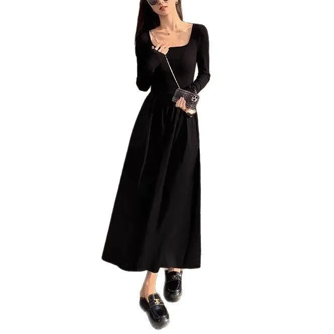 Women's black knitted A-line dress with square collar and long sleeves on hanger