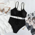 Black women's bikini swimsuit with sling top and high-waisted shorts on a white background