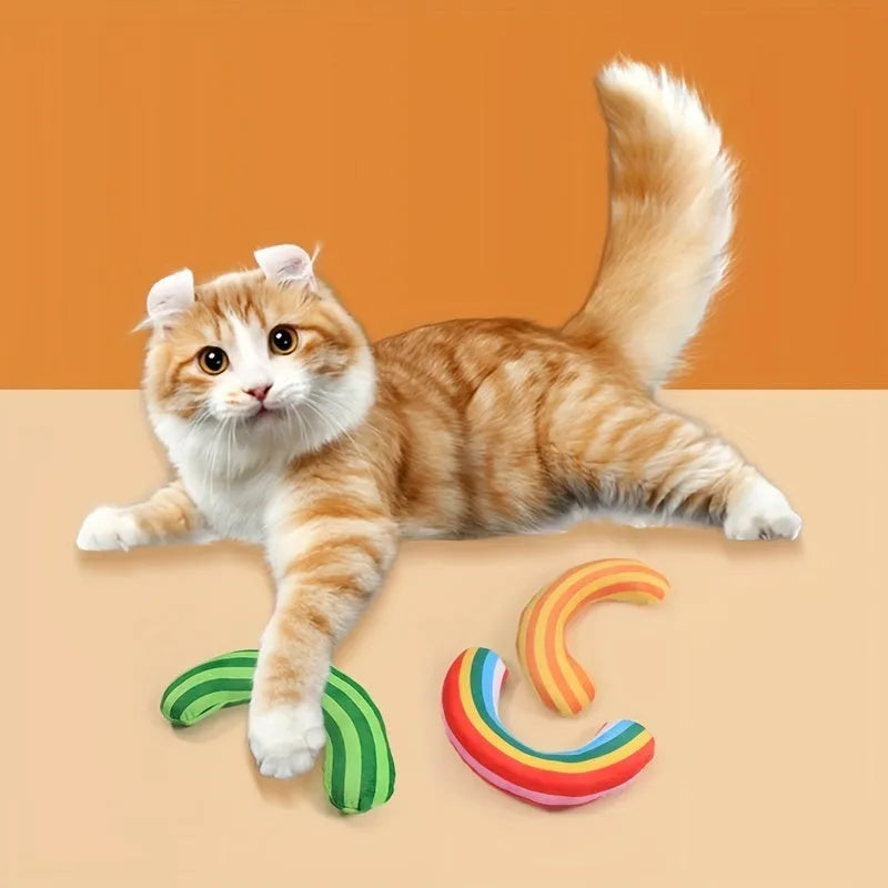 Green, Rainbow, and Yellow cat toy set with noise maker, catnip strip, and striped pillow.