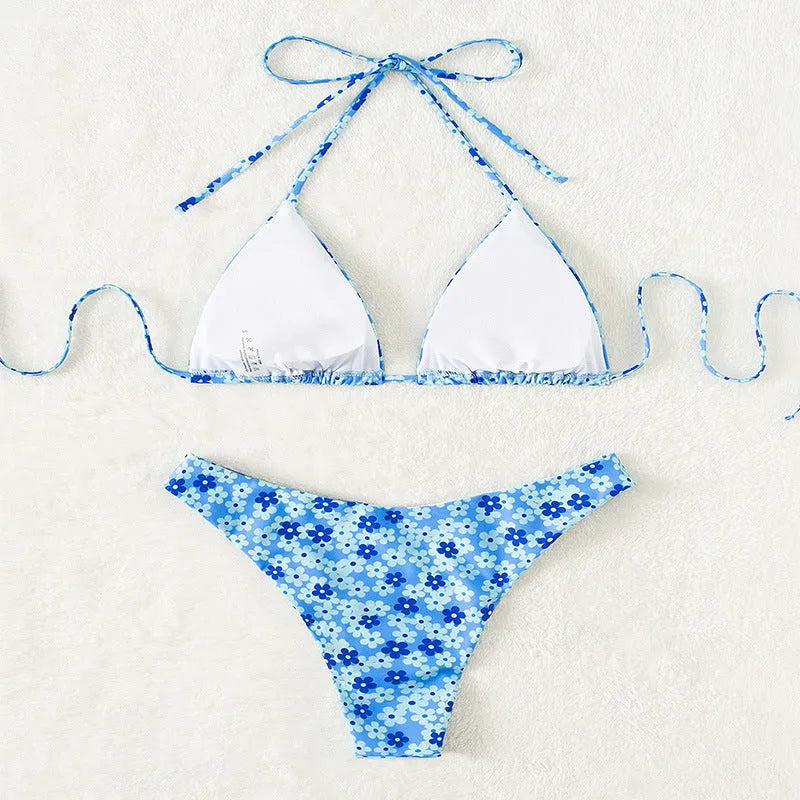 Blue printed women's swimsuit with lace-up detail and split design, includes top and shorts