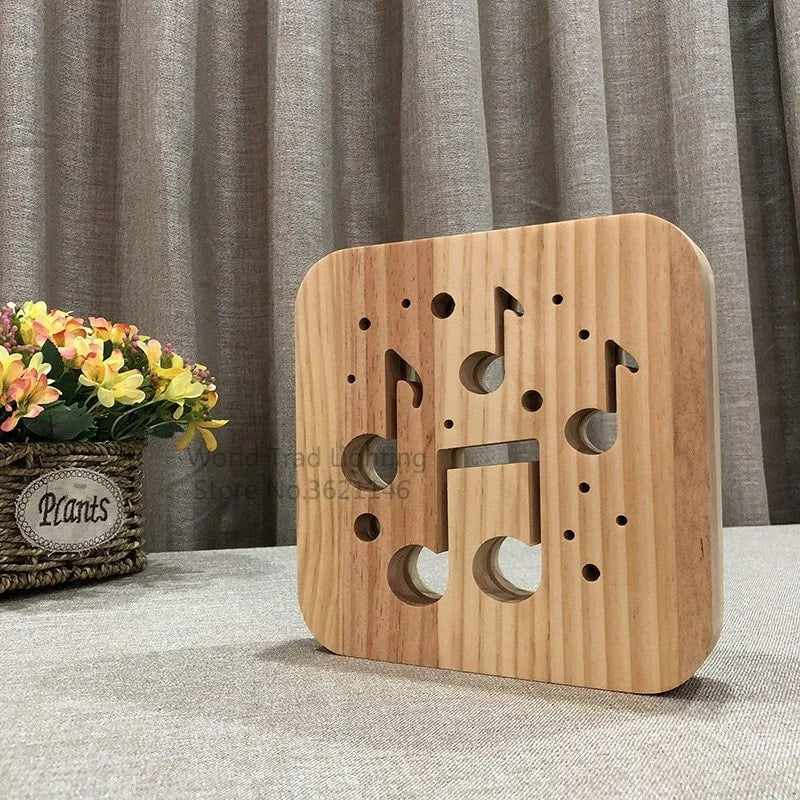 Pine wood cube LED lamp with warm white light, showing USB cable connection