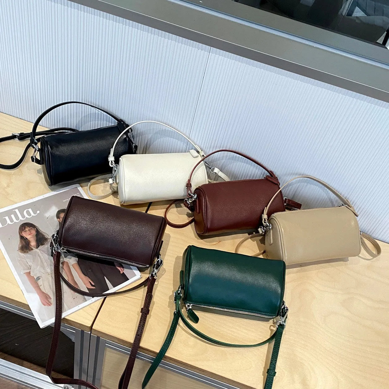 Genuine vegetable tanned leather crossbody phone bag with cylindrical shape and single shoulder strap