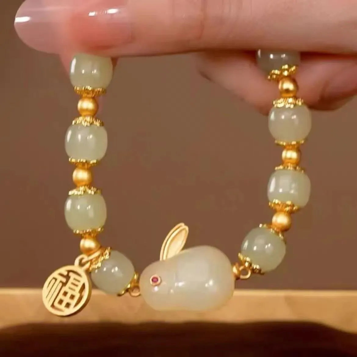 Green jade hare bracelet with black base, fu character design, and lily decorative elements