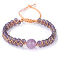 Close-up of a blue Tigereye hand-woven bracelet with a geometric pattern and pull closure.