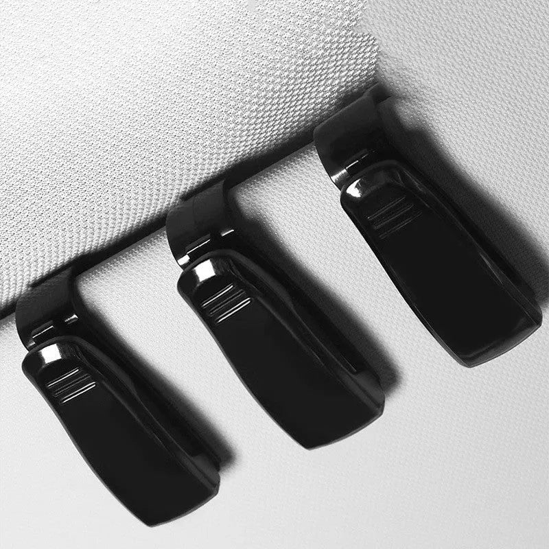 Black plastic car sun visor clip organiser for glasses, tickets and ID cards measuring 6.5 by 2.3 centimetres