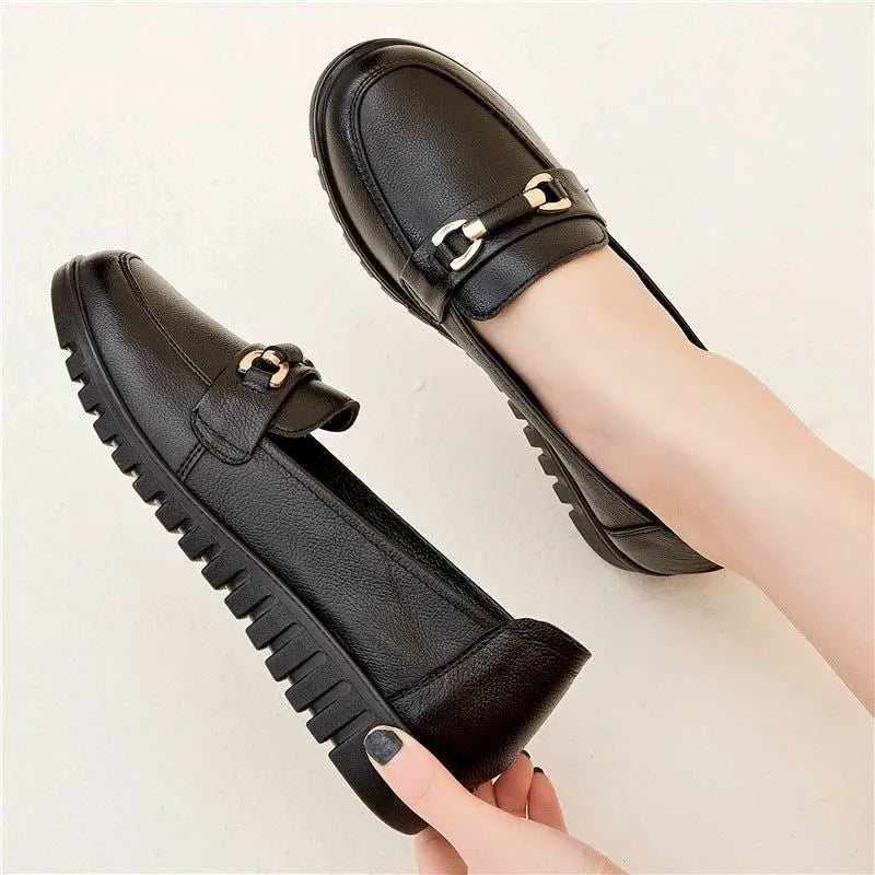 Black women's slip-on pumps with a round toe, low flat heel, and soft rubber sole.