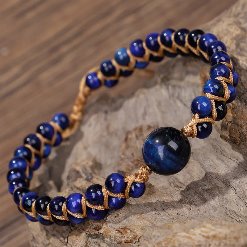 Close-up of a blue Tigereye hand-woven bracelet with a geometric pattern and pull closure.