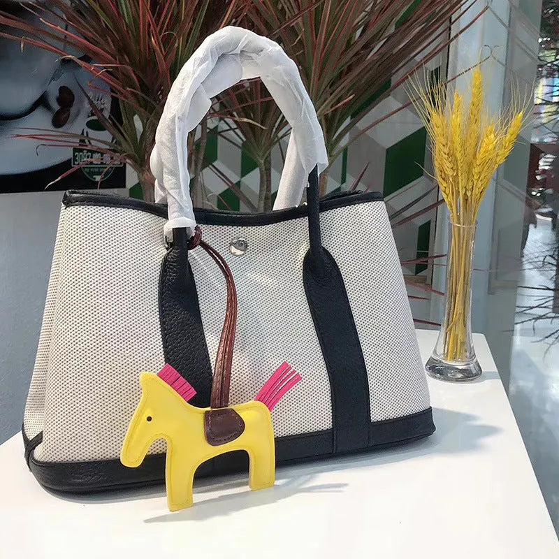 Women's canvas bucket tote bag with leather details in black, brown, gray, or red colours