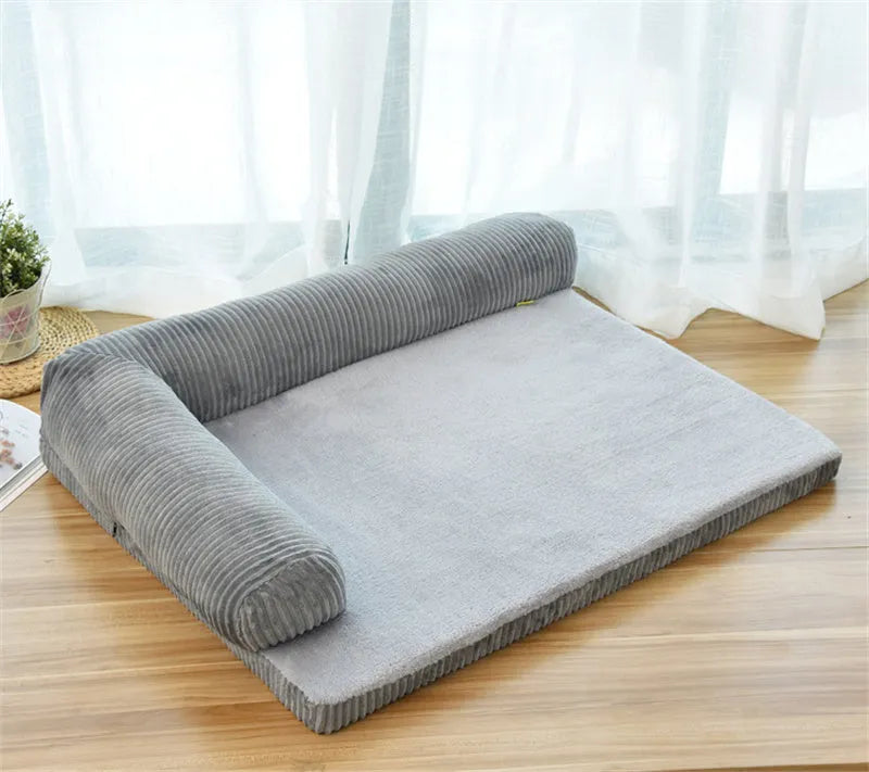 Corduroy pet dog bed with bolster sides on a non-slip base, shown in grey colour.