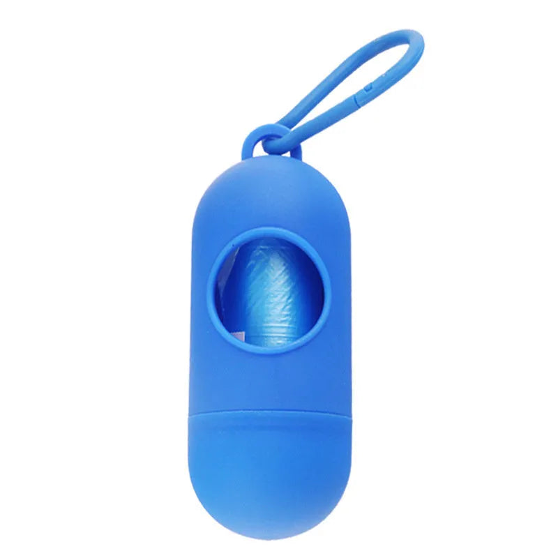 Small black dog waste bag holder with a side clip and Velcro strap, shown next to a roll of poop bags.