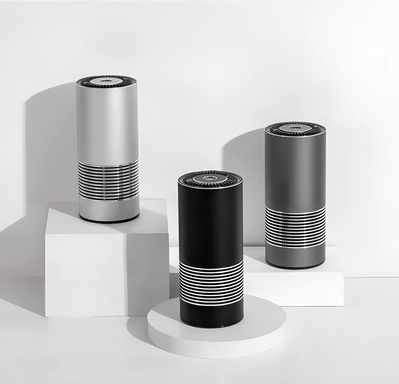 Compact cylindrical car air purifier in metallic grey showing 65mm diameter, with USB power cable.