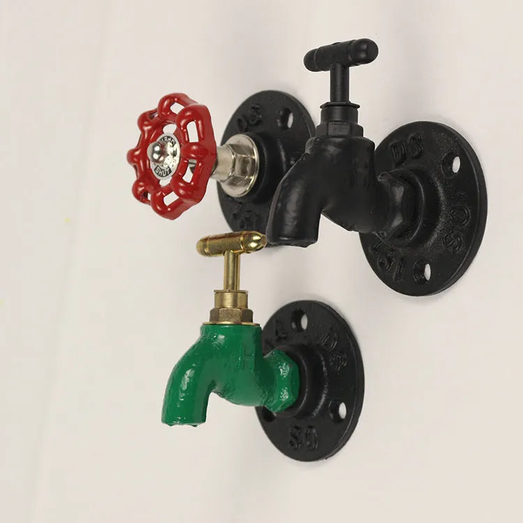 Metal water pipe style towel rack hook in modern design mounted on a wall.