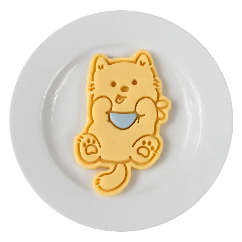 Plastic three dimensional biscuit mold with cartoon puppy designs including birthday hat style
