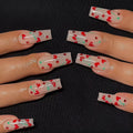 Set of 24 cherry blossom French manicure press-on nails with red diamond accents and glue tube