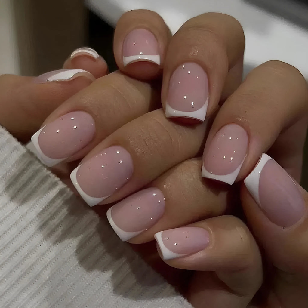 Twenty-four white plaid pattern fake nails with square tips arranged on a surface.