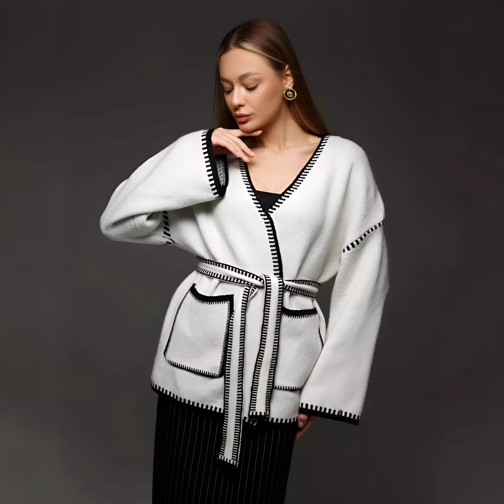 Loose fit knitted cardigan sweater in black, camel, or white colour on a hanger