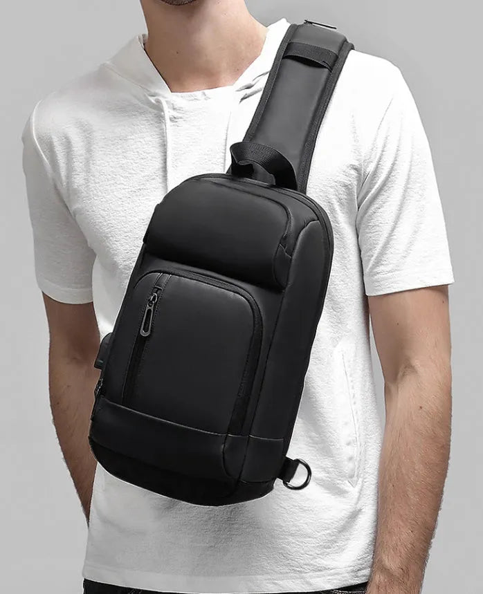Black medium-sized PVC shoulder bag showing internal organisation pockets and air cushion strap