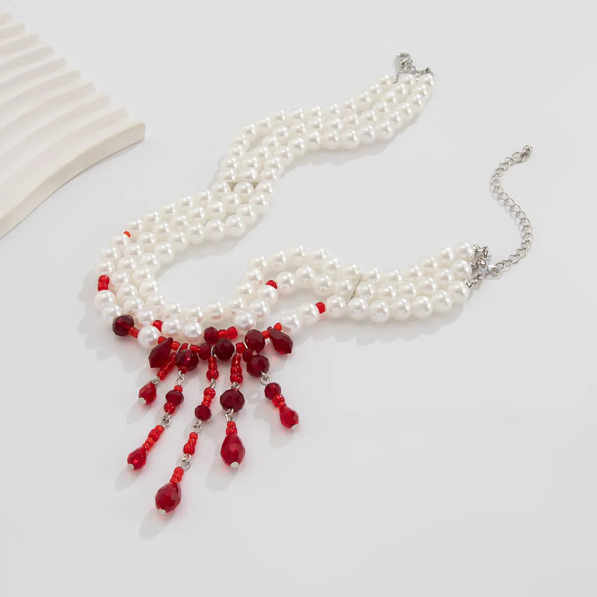 Men's Halloween necklace with geometric blood drop pendant, artificial crystal details, and imitation pearl chain.