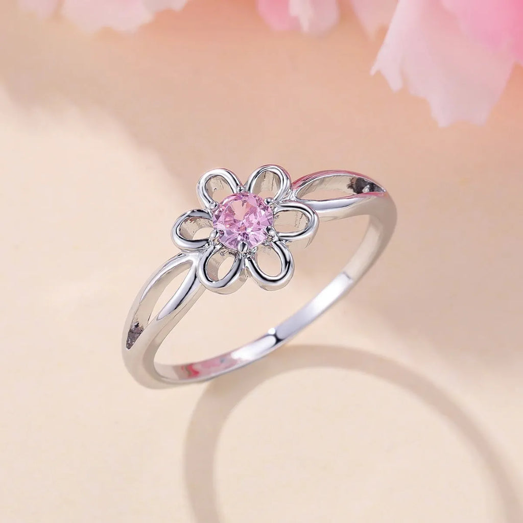 Ladies floral hollow-out fashion ring in white gold powder finish showing detailed openwork pattern