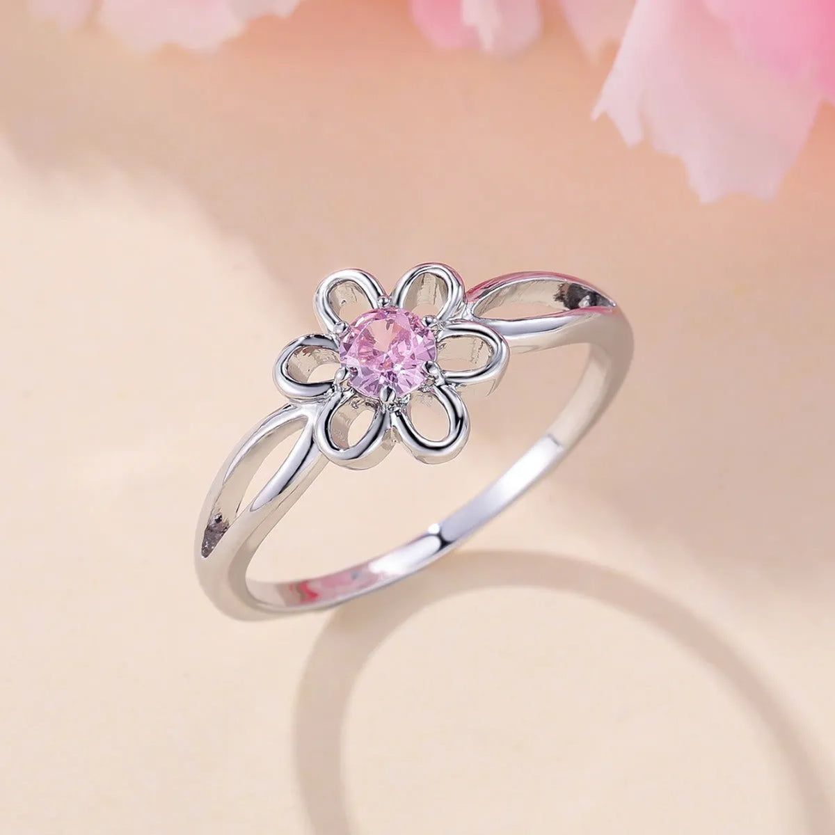 Ladies floral hollow-out fashion ring in white gold powder finish showing detailed openwork pattern