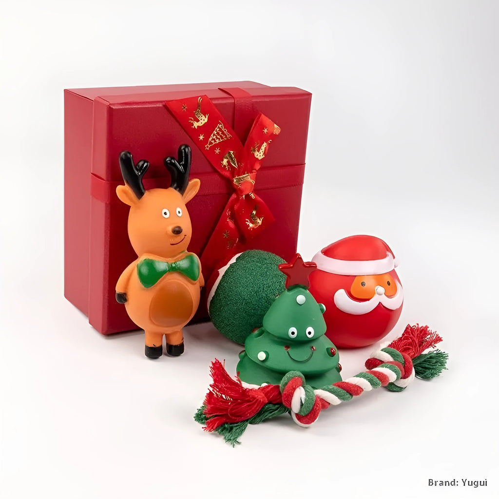 A set of red, green, and white vinyl Christmas dog toys including a Santa head, bite rope, and tennis ball.