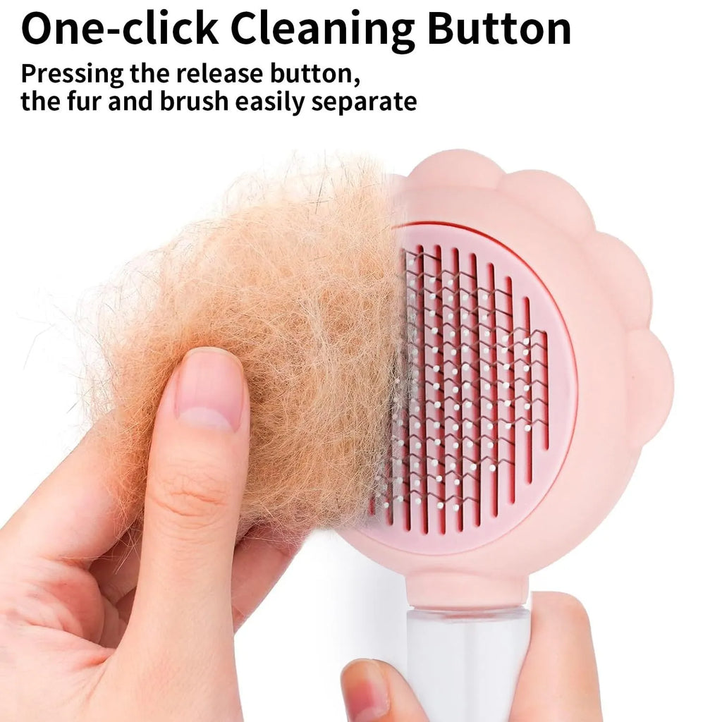 Grey spray cat brush with a release button and stainless steel bristles on a white background.
