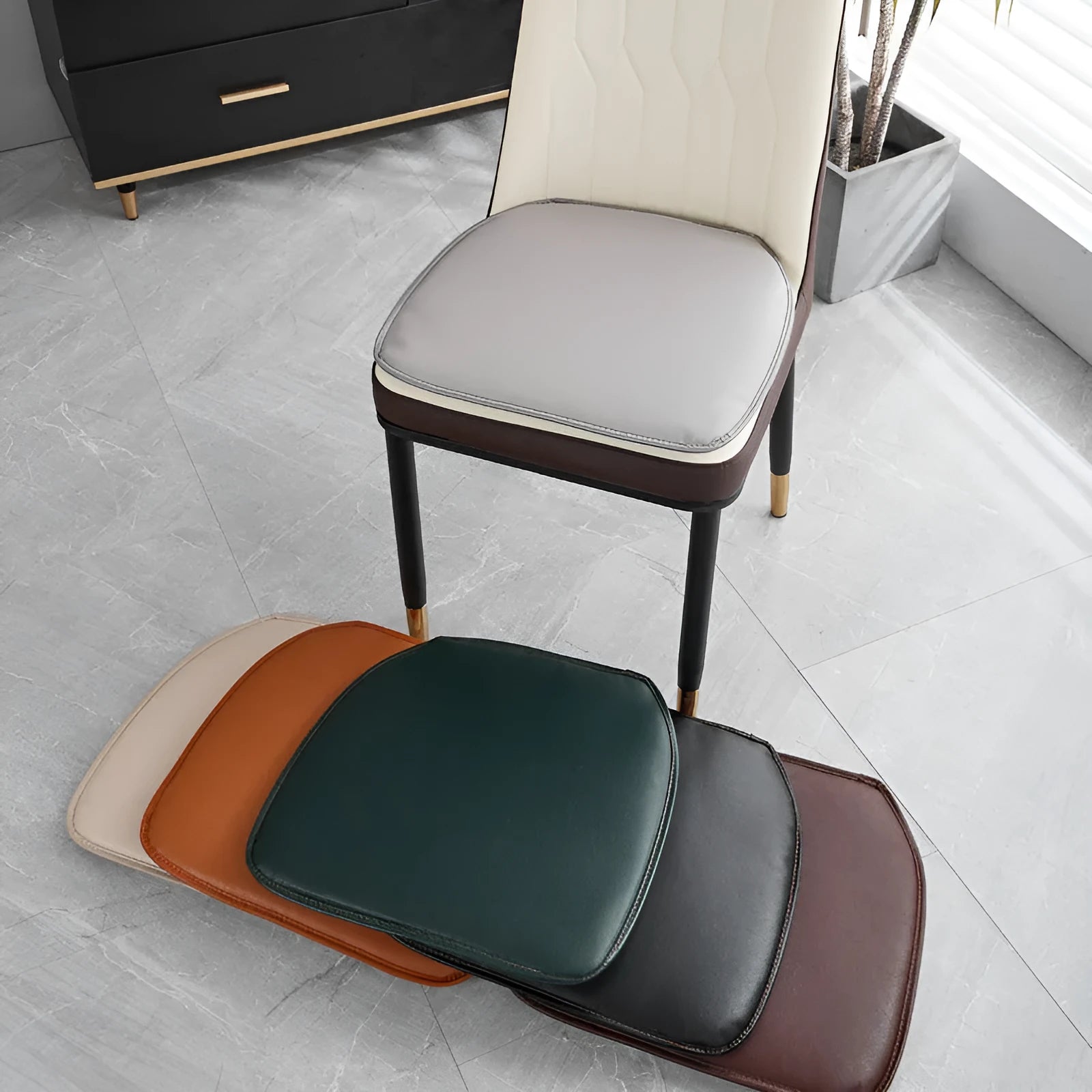 Leather horseshoe-shaped non-slip seat cushion in a solid colour on a wooden chair